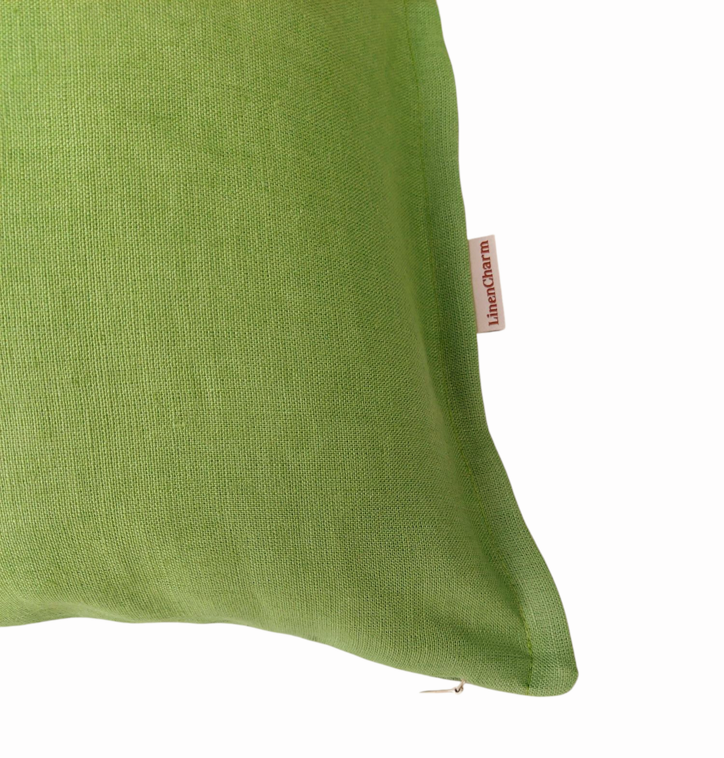 Beautiful throw pillow cover in soft linen fabric with a subtle green tone, small flange detail, and hidden zipper.