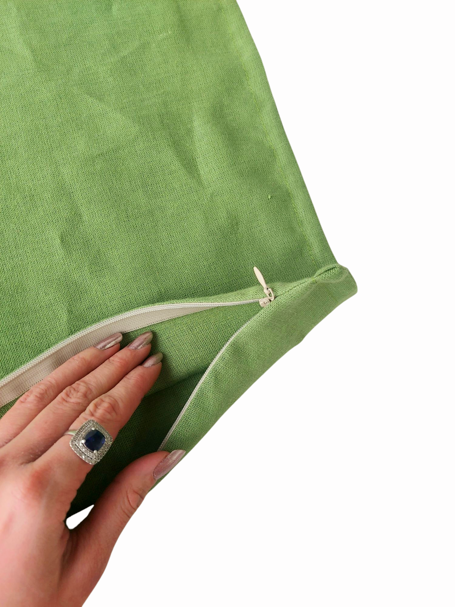 Minimalist green linen cushion cover with a delicate flange and concealed zipper, ideal for modern interiors.