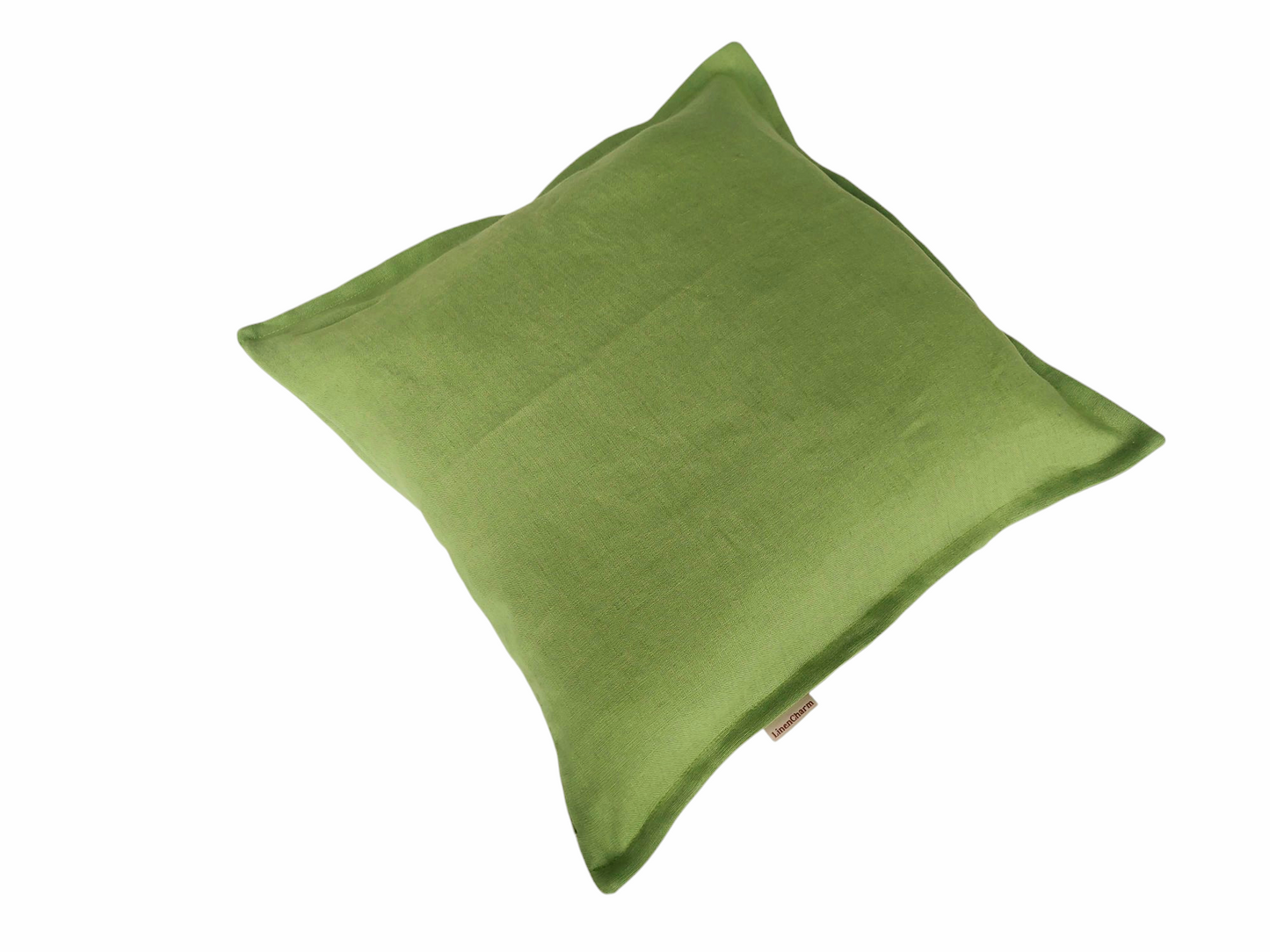 Handmade linen cushion cover in a fresh green shade, featuring a decorative small flange and invisible zipper closure.