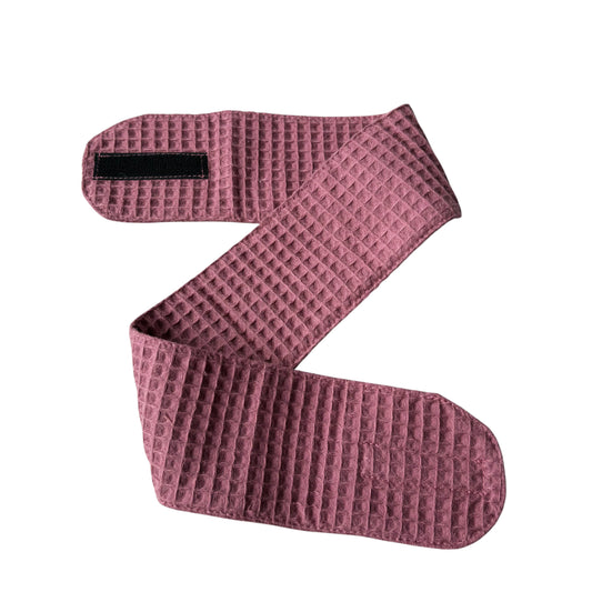 Pink textured bandage roll on a white background
