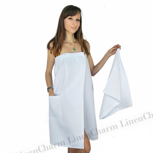 Woman wearing a white towel with a plain white background
