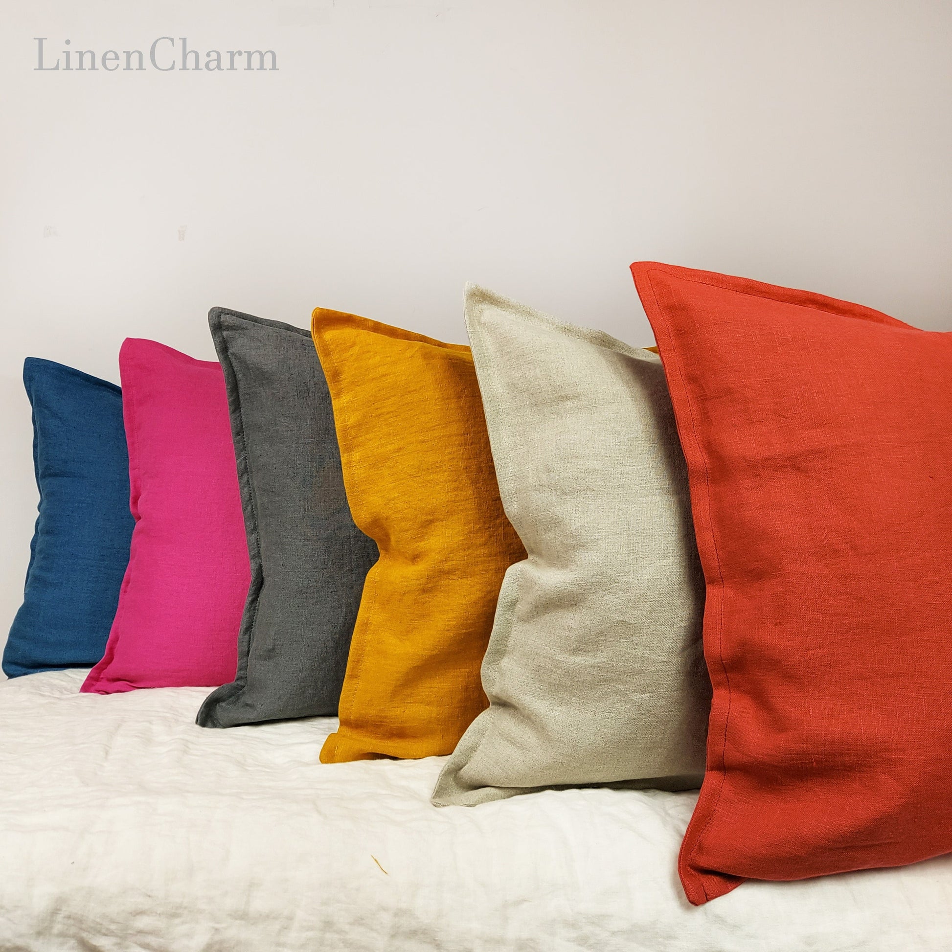 Linen pillow covers in mustard, denim, and fuchsia, made from natural fabric, perfect for home decor.