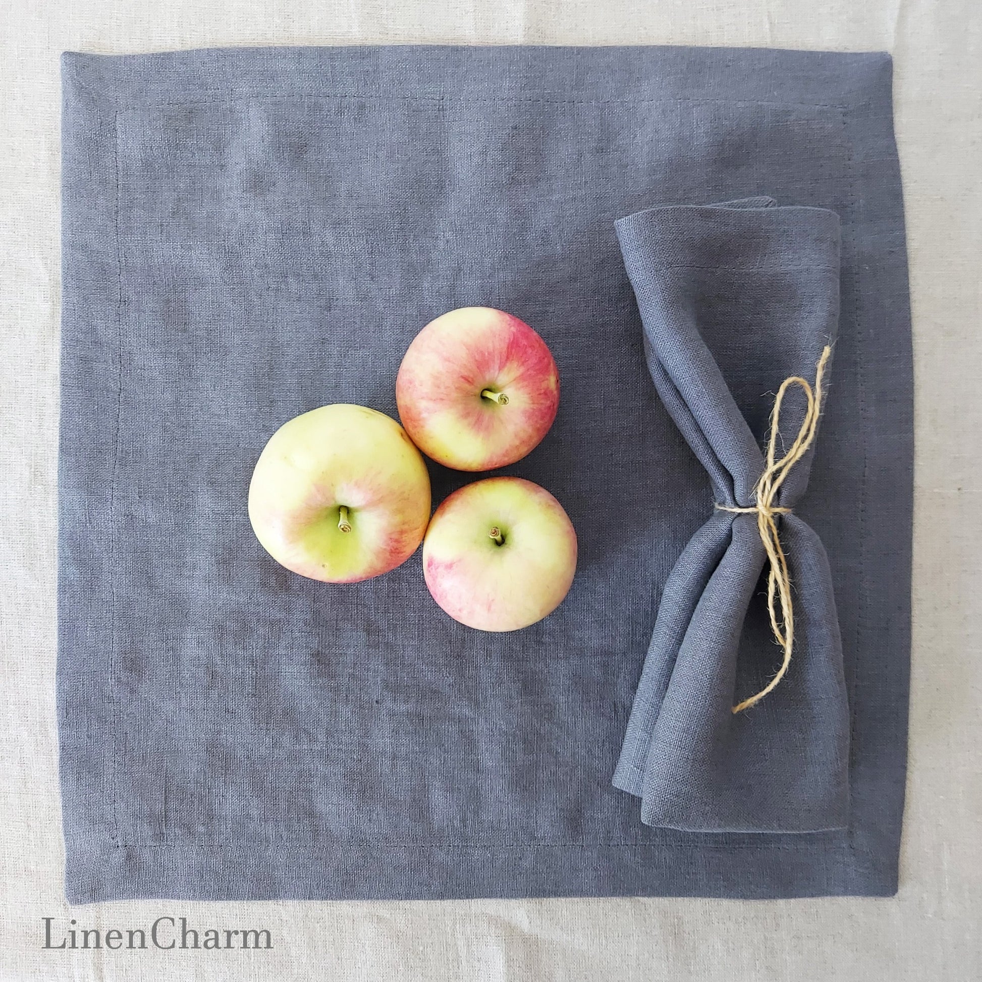 Rustic table setting with grey linen napkins and florals