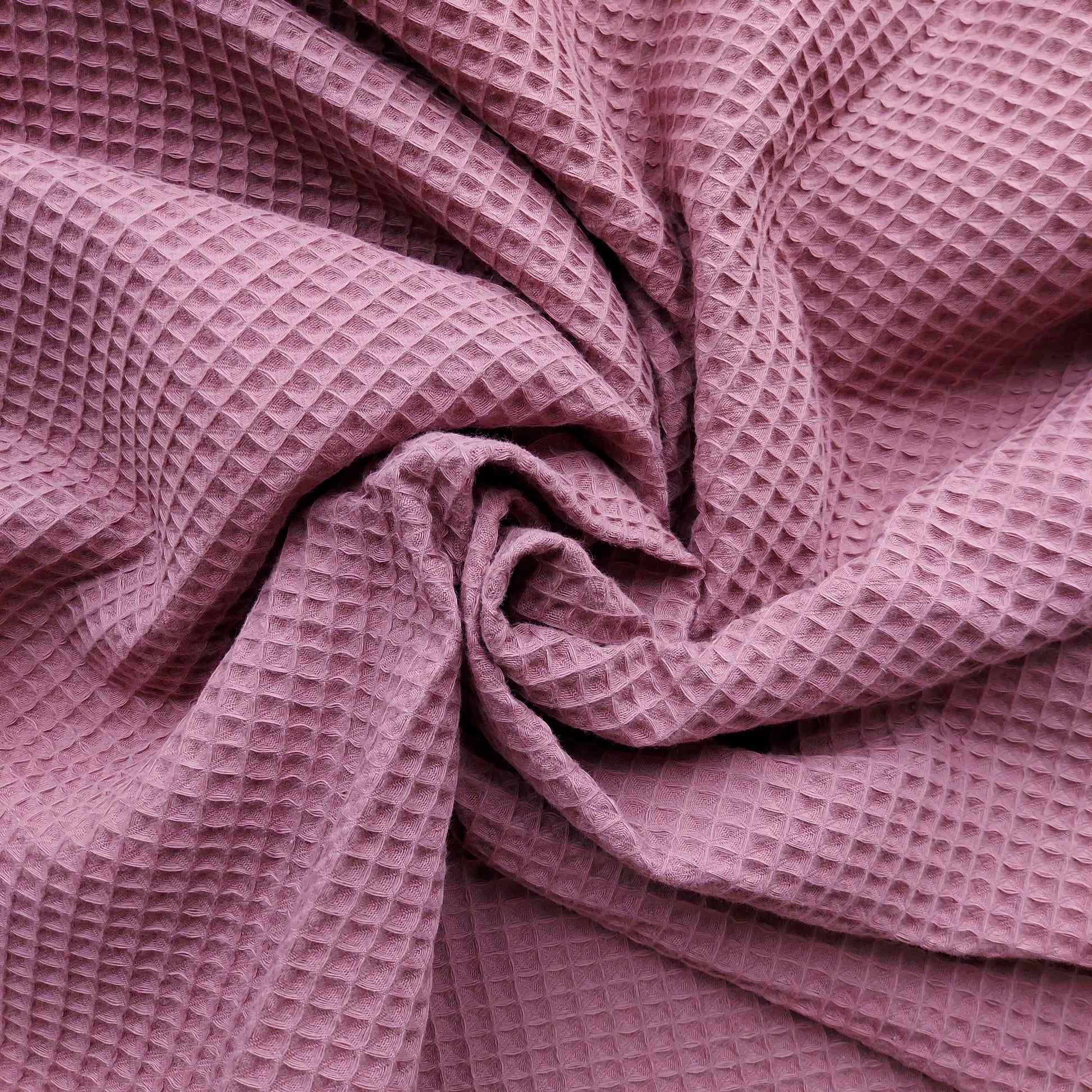 Close-up of waffle-textured pink fabric