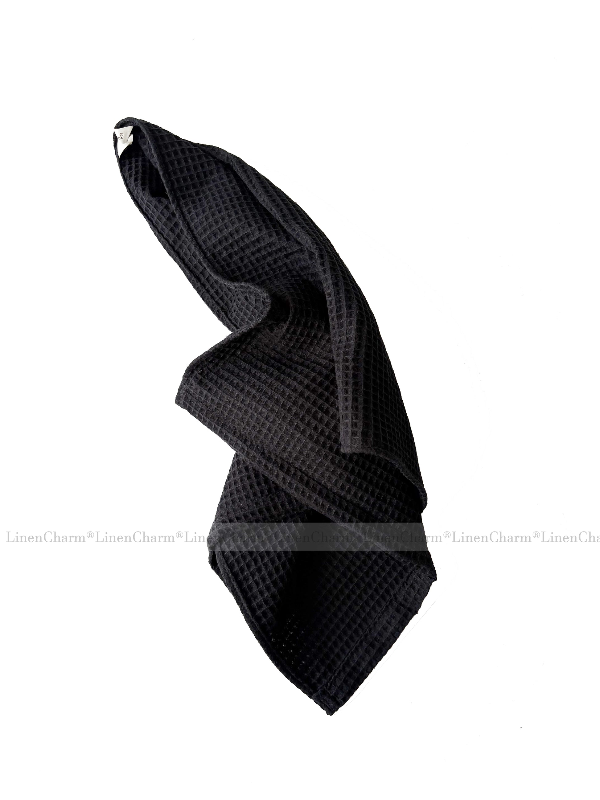 Black textured towel on a white background