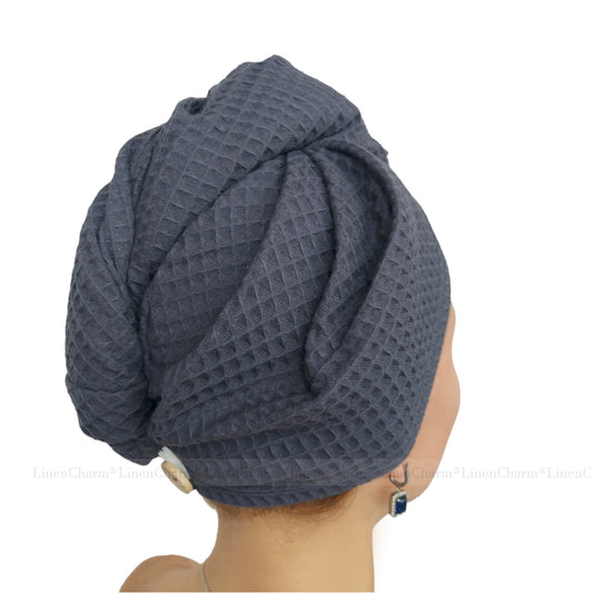 Person wearing a textured grey hair turban on a white background