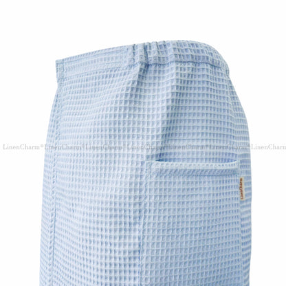 Light blue checkered apron on a white background