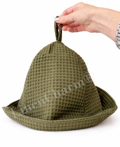 Moss green sauna hat made from breathable waffle cotton fabric.