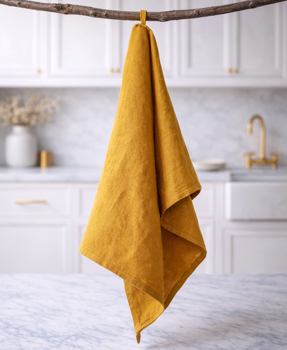 Mustard yellow towel hanging on a branch in a kitchen setting