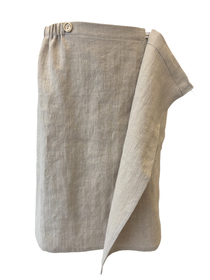 Folded beige towel with button closure on a white background