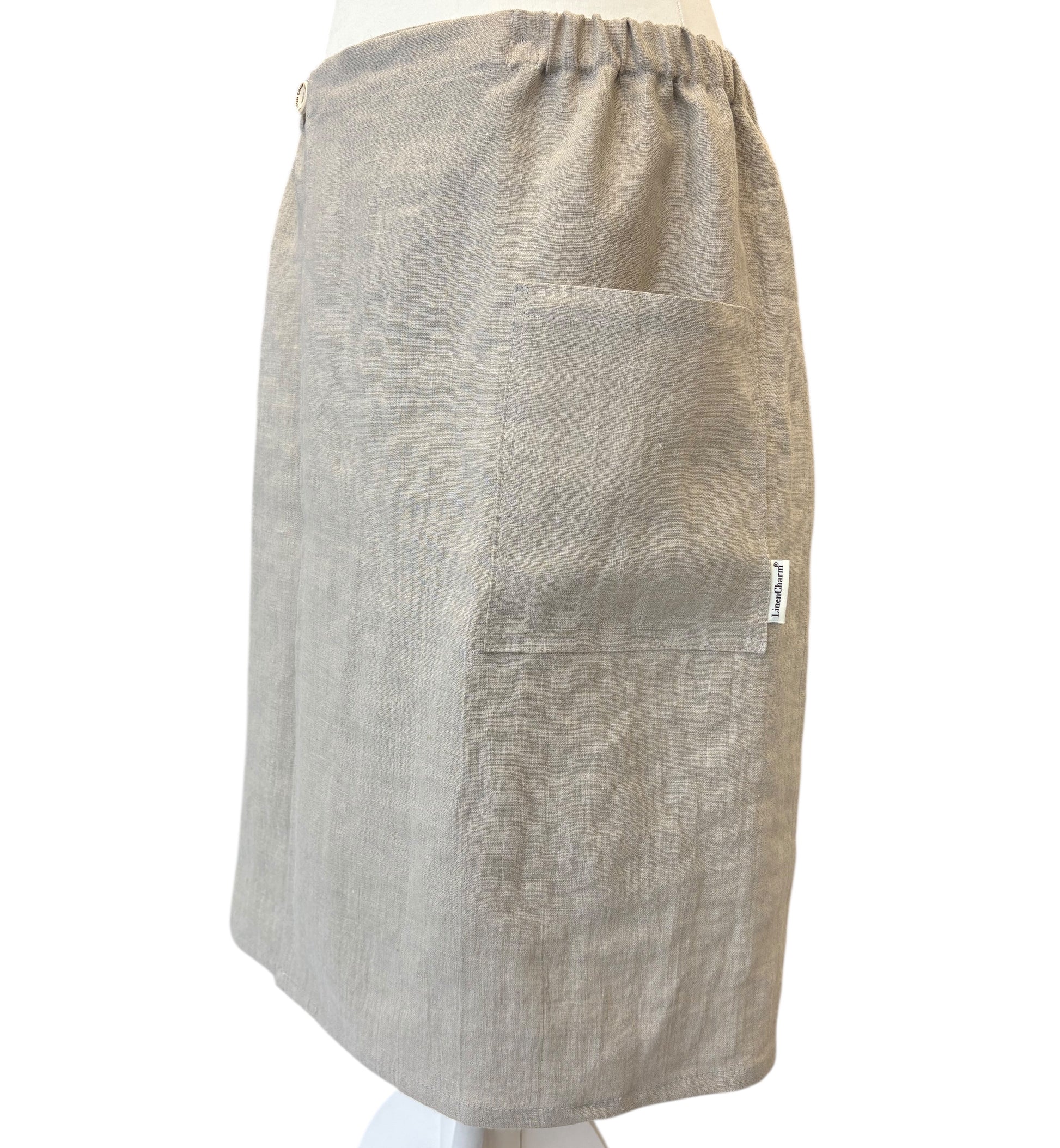 Beige apron on a mannequin against a white background