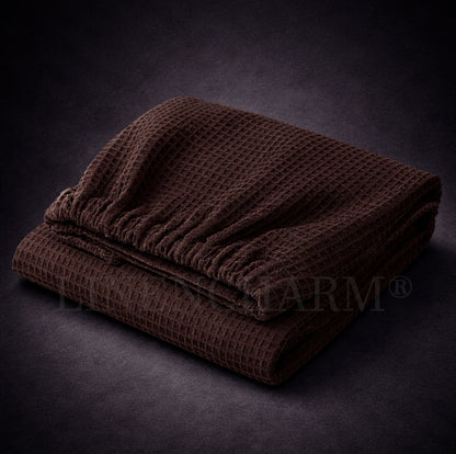 Folded brown textured towel wrap on a dark background