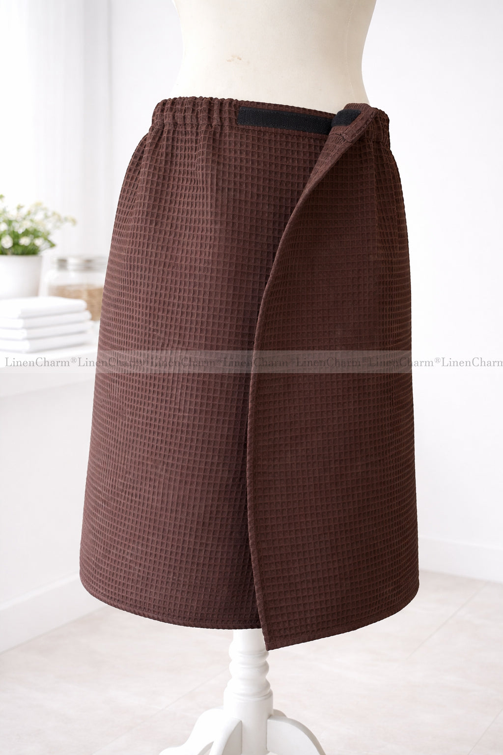 Brown checkered skirt on a mannequin against a white background