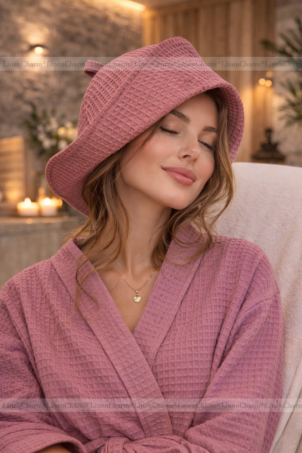 Woman wearing a dusty pink waffle cotton sauna hat during a relaxing spa experience.
