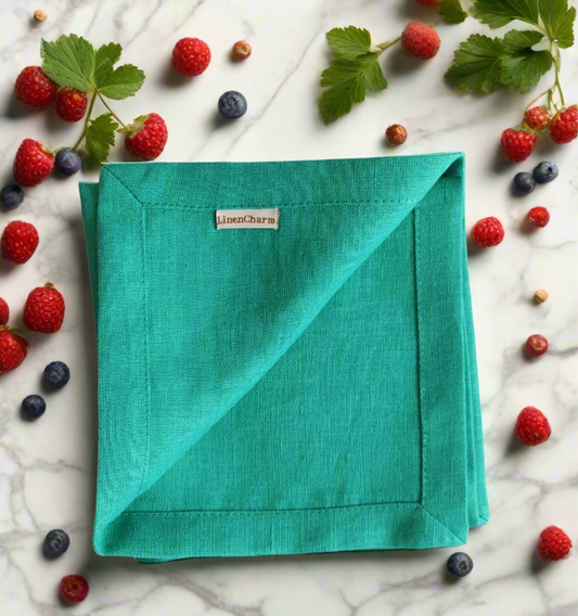 Flat lay of emerald green linen napkins – handmade 100% linen