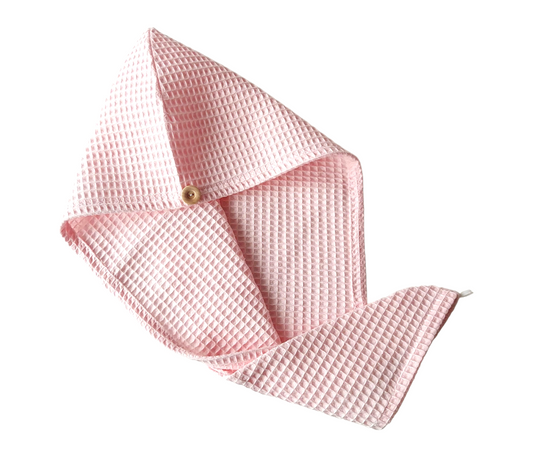 Pink textured fabric with a button on a white background