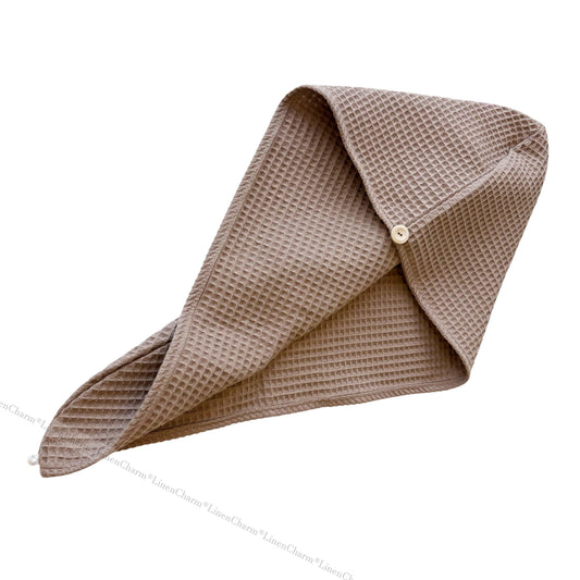 Brown waffle-textured fabric folded into a triangle shape on a white background