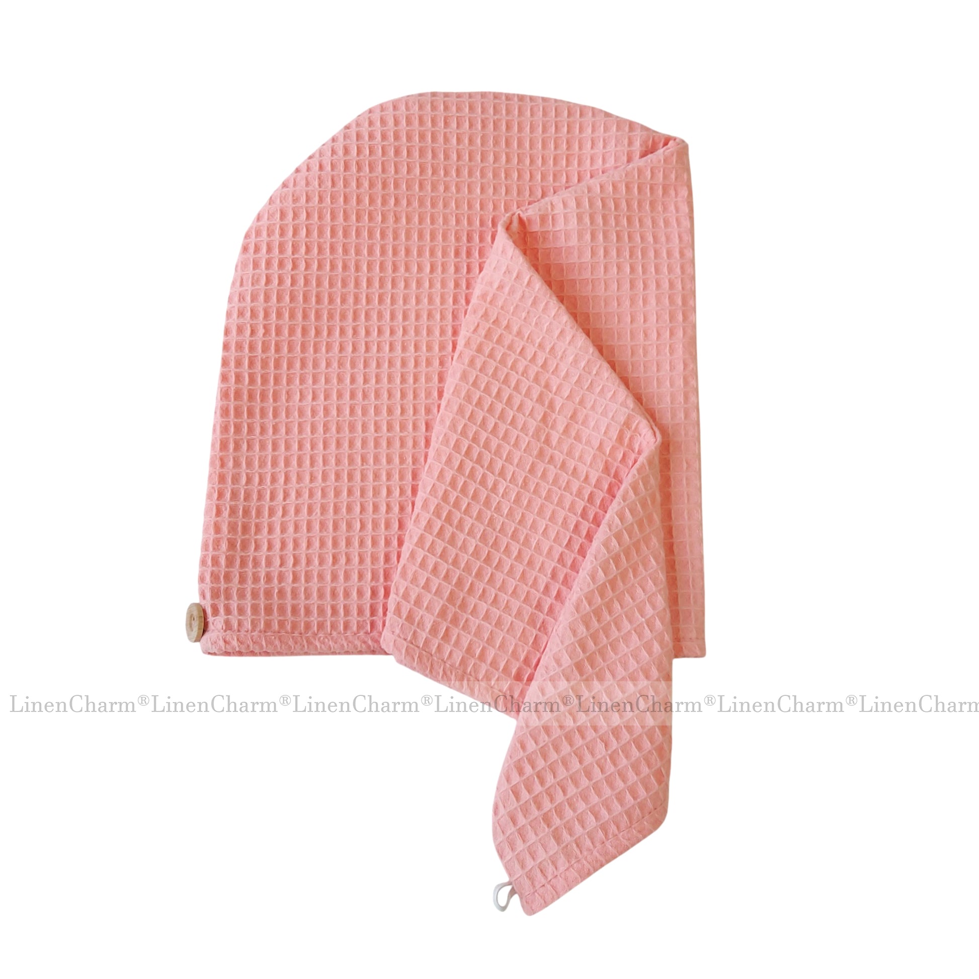 Pink textured towel on a white background