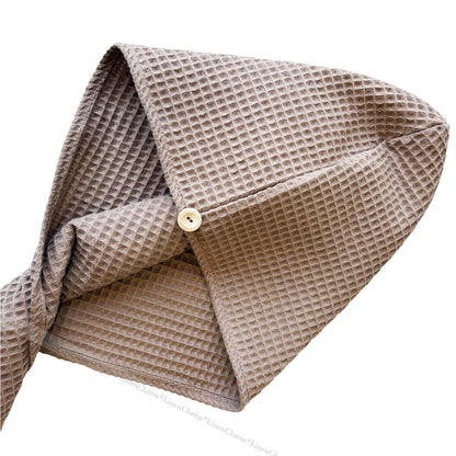 Beige textured fabric with a button on a white background